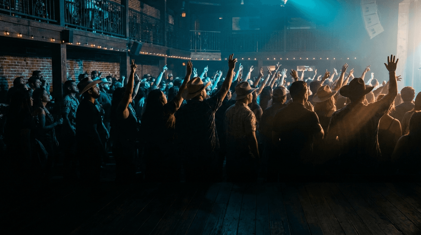 Concert crowd with cyan ambient lighting at The Reef, San Antonio